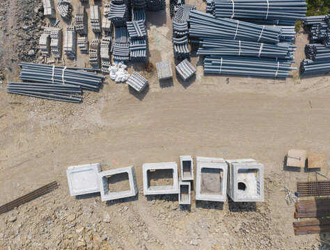 Aerial Construction Site Showing Concrete Pipes and Building Mat