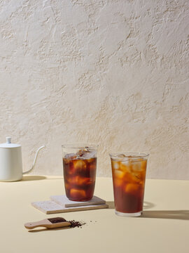 Two Glasses of Iced Coffee Against Neutral Background
