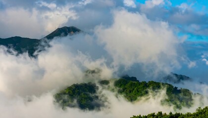 Misty mountain range with a peak emerging from clouds