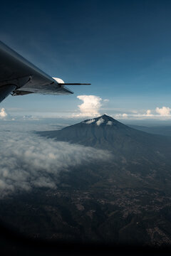 View of Volcano Peak and Clouds from Aircraft Wing