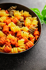 pasta trottole tricolor pasta spiral dish twisted Italian food tasty snack fresh delicious gourmet food background on the table rustic top view copy space  vegan and vegan food