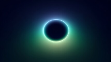 A dark circular shape surrounded by a glowing halo of blue and green light against a black background. The scene conveys a sense of mystery and cosmic beauty.