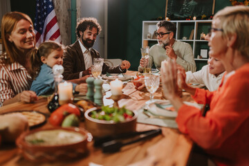 Happy family celebrating thanksgiving day with festive dinner at home