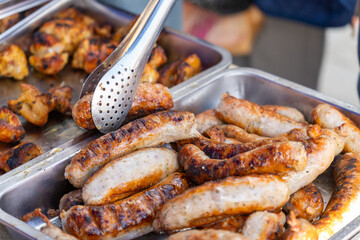 Sizzling street food feast: grilled sausages, shashlik, and golden french fries