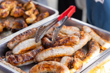Sizzling street food feast: grilled sausages, shashlik, and golden french fries