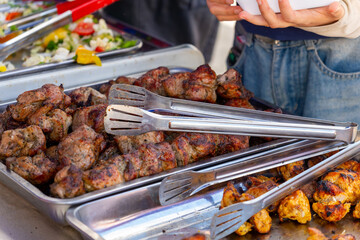 Sizzling street food feast: grilled sausages, shashlik, and golden french fries