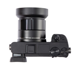 Modern mirrorless digital camera with lens and lens hood cut out, top view