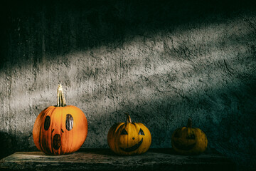 scary funny Halloween pumpkins on wooden table