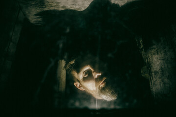 scary man behind window with spider nets at night Halloween horror background