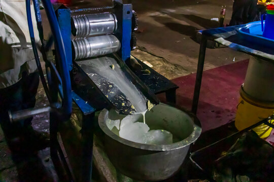 Sugarcane juicing machine makes a fresh sugarcane juice at Forodhani garden evening market in Stone Town, Zanzibar, Tanzania