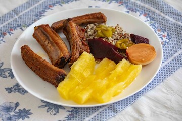 healthy superfood well balanced in nutrients, roasted pork chops,cassava, quinoa, salad, vegetables