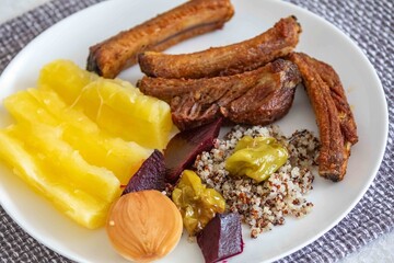 healthy superfood well balanced in nutrients, roasted pork chops,cassava, quinoa, salad, vegetables