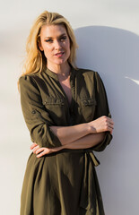 Naklejka premium Summer Radiance: Blonde Beauty Glows Outside Her Home at Golden Evening Hour