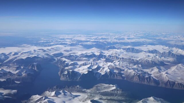 Aerial video of glacier-carved fjords and snowy peaks on Baffin Island