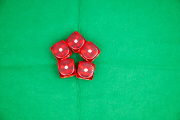 Red dices on green background, symbolizing casino games, gambling, and poker tournaments.