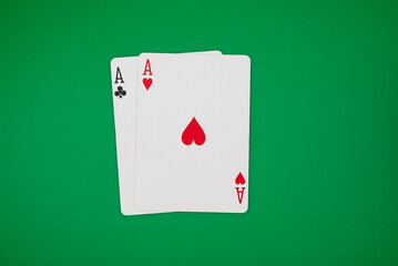 2 aces on green background, symbolizing casino games, gambling, and poker tournaments.