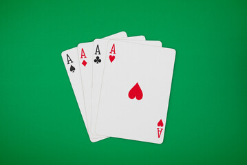 4 aces on green background, symbolizing casino games, gambling, and poker tournaments.
