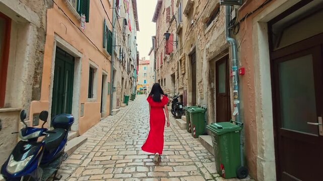 Woman In Red Dress Walking Narrow Cobblestone Street, Rovinj Croatia Old Town Alley With Rustic Stone Houses, Romantic European Travel Destination