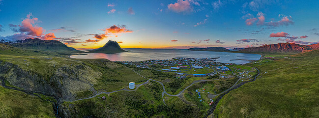 Flateyri village in Iceland Westfjords aerial panorama at sunset with colorful clouds calm fjord waters and dramatic surrounding mountains © Fineshot