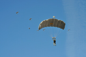 Parachute drop of uniformed soldiers