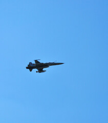F-16 fighter Falcon flying through the blue sky