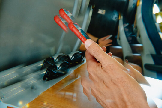 kaleidoscopic image of a man using his phone in an airplane or a train
