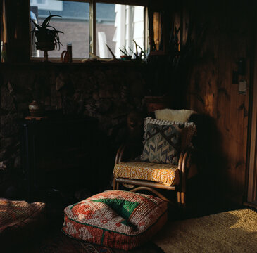 Cozy bohemian reading nook in warm sunlight

