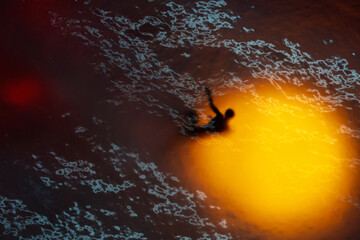 Drifting Alone Beneath the Surface of Light and Darkness