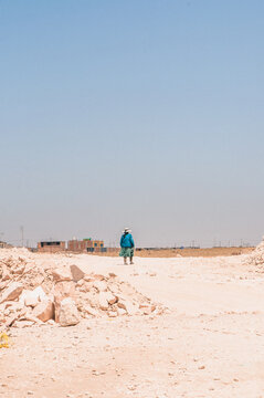 Woman Walking Through Desert Landscape, Peru