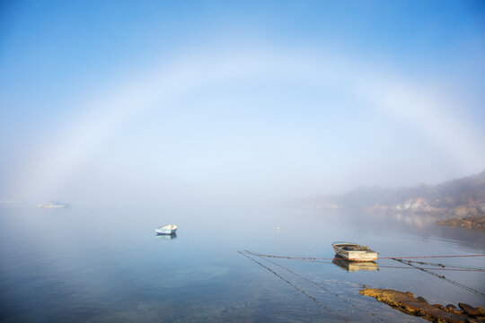 A fogbow and two small dinghies. Porter Bay. South Australia.