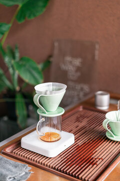 Coffee Brewing Setup With Green Dripper on Wooden Surface