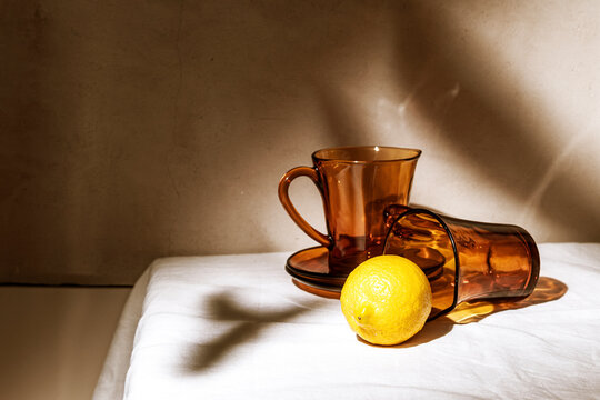 Warm Light Shines on Amber Glasses and a Fresh Lemon