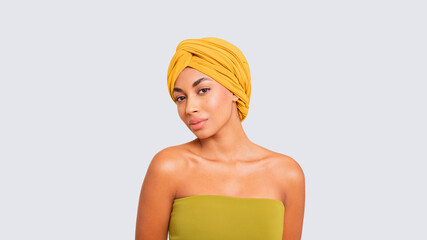 Elegant young Latin American woman with a yellow scarf 