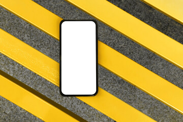 Smartphone with white isolated screen on Vibrant Yellow Striped bench