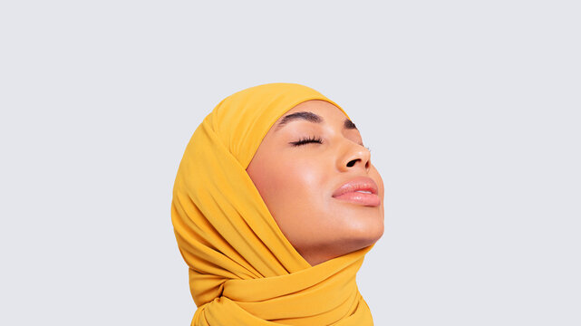 Peaceful woman with yellow scarf and closed eyes