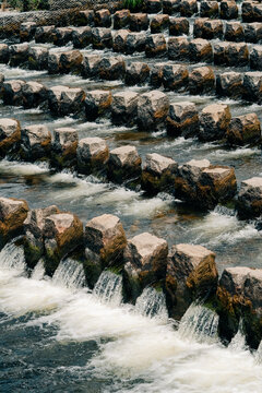 Beautiful Cascading Water Flows Over Stone Steps at a Tranquil Site