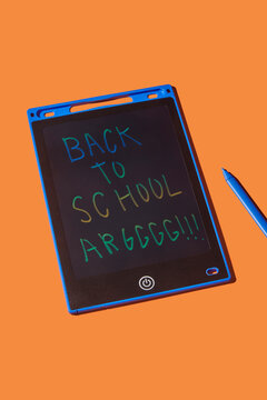 text back to school argggggg written on a LCD drawing board