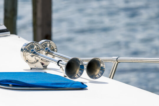 Close up view of dual shiny horn on boat roof.