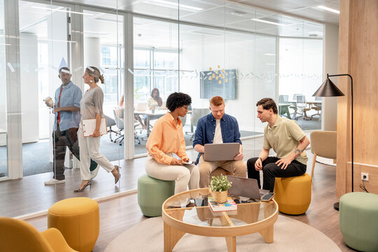 Business team collaborating on project in modern office