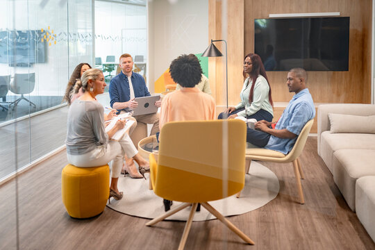 Multicultural business team collaborating in modern office meeting