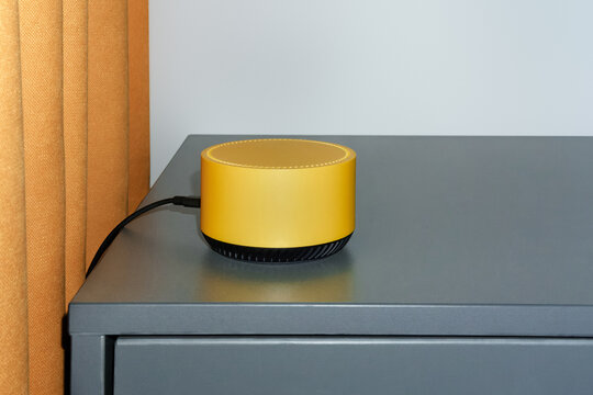 Stylish Yellow Smart Speaker on Gray Table With a Warm Backdrop