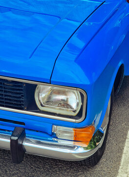 Classic blue car parked in a sunny outdoor location