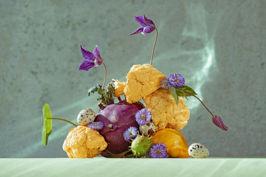 Vibrant assortment of vegetables and flowers arranged artistically