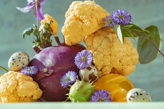 Colorful arrangement of vegetables and flowers on a table