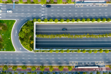 Top View of Urban Road and Sunken Tunnel with Green Landscaping