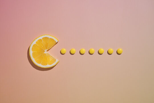 A lemon slice creatively mimics a video game character eating pills