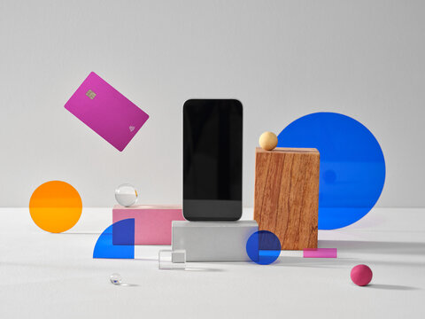 Modern Artistic Composition Featuring Smartphone and Pink Bank Card