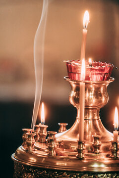 Candles and incense create a serene atmosphere in a temple setting