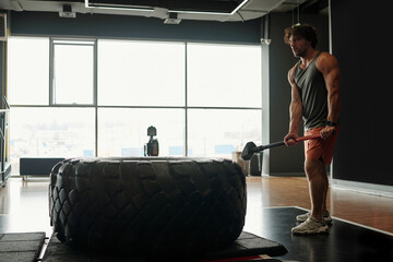 Man Starting Sledgehammer Workout