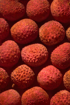 Close-up view of ripe lychees, showcasing the vibrant red color